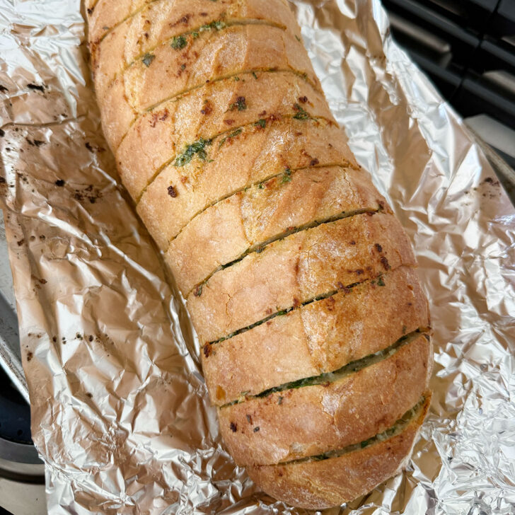 Herb and garlic bread loaf after heating in the oven.