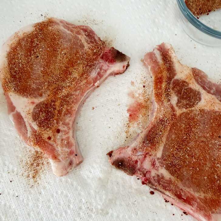 Bone-in pork chops rubbed with the spice mix before cooking.