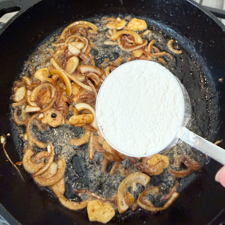 Adding flour to the skillet.